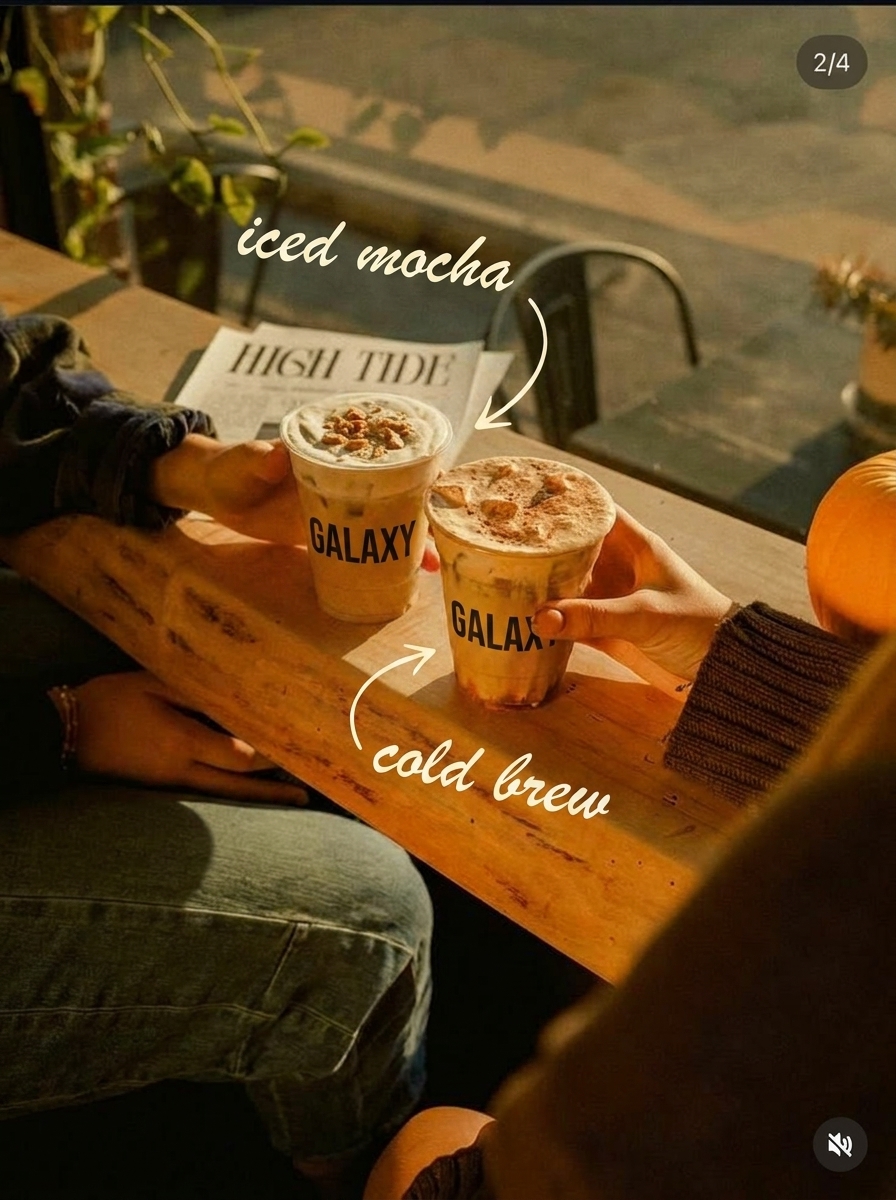 Moody autumn cafe table with two iced mocha and cold brew cups in warm window light